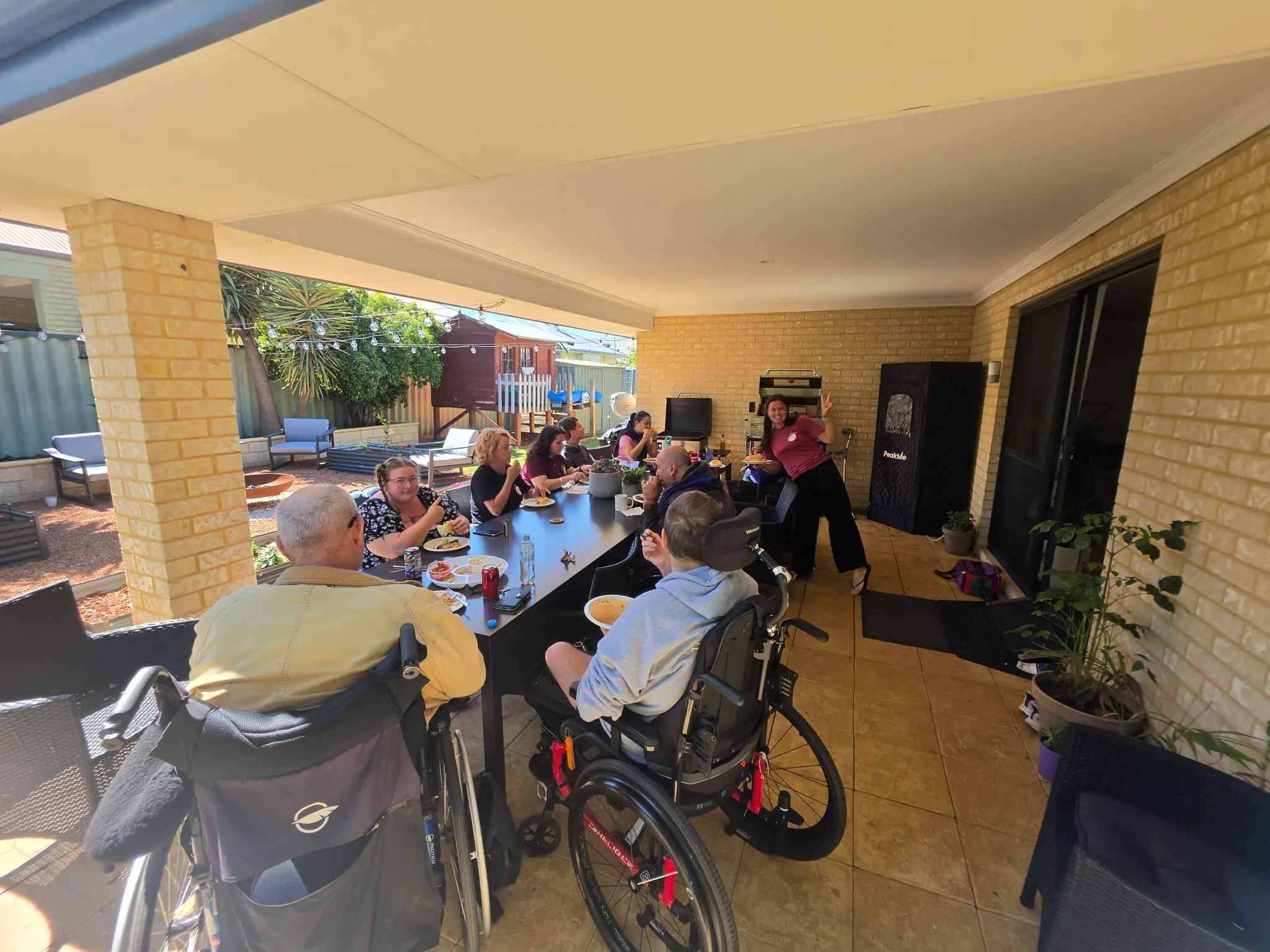 Participants and Crew members sharing a meal together on a covered patio