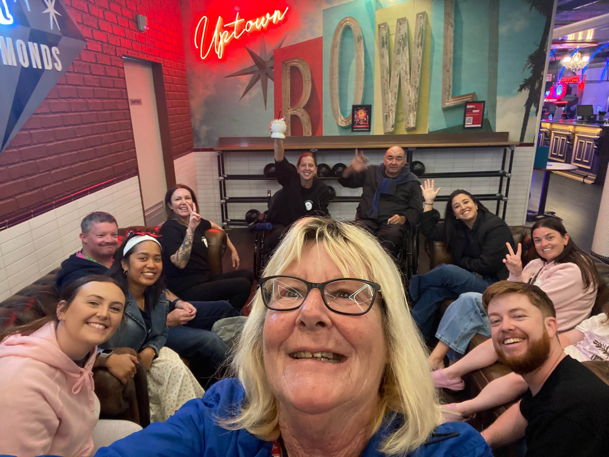 Happiness Crew members and participants celebrating together at a bowling outing