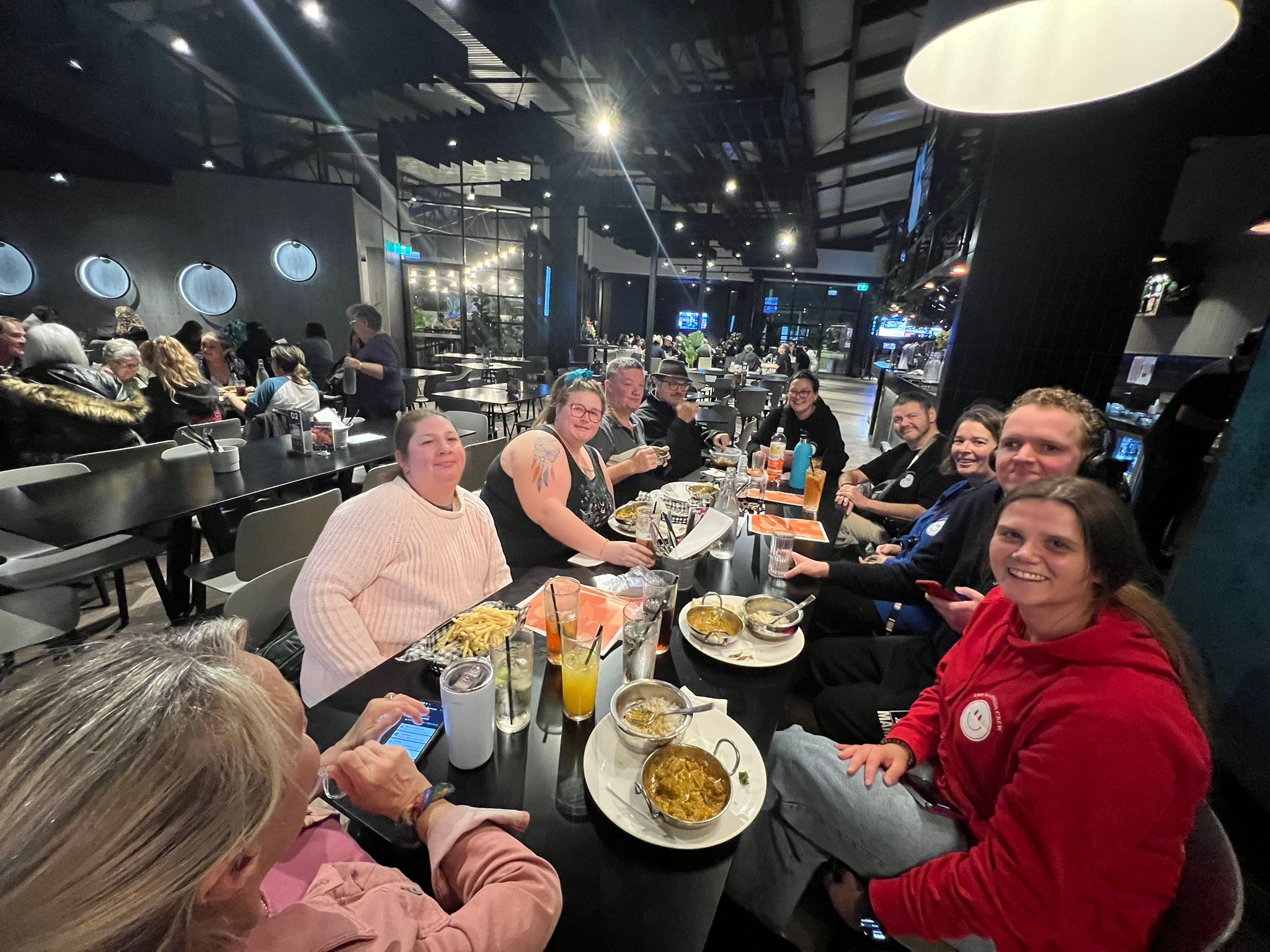 Happiness Crew participants and team members sharing a dinner out together