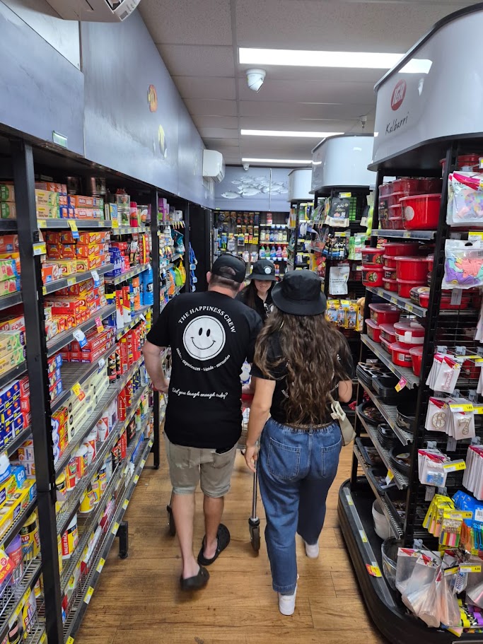 A participant and Happiness Crew member shopping together