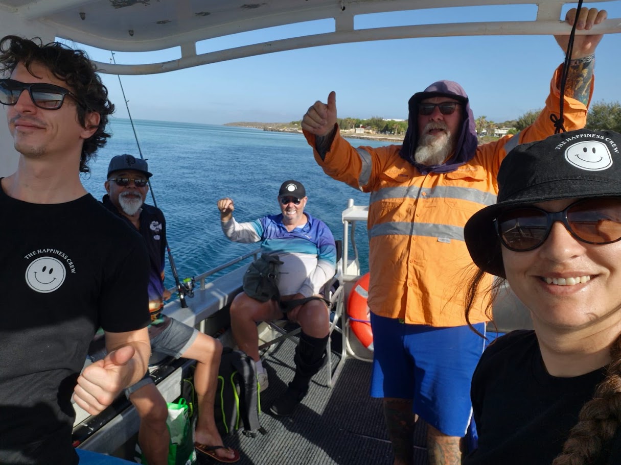 Happiness Crew participants sharing time together on a boat