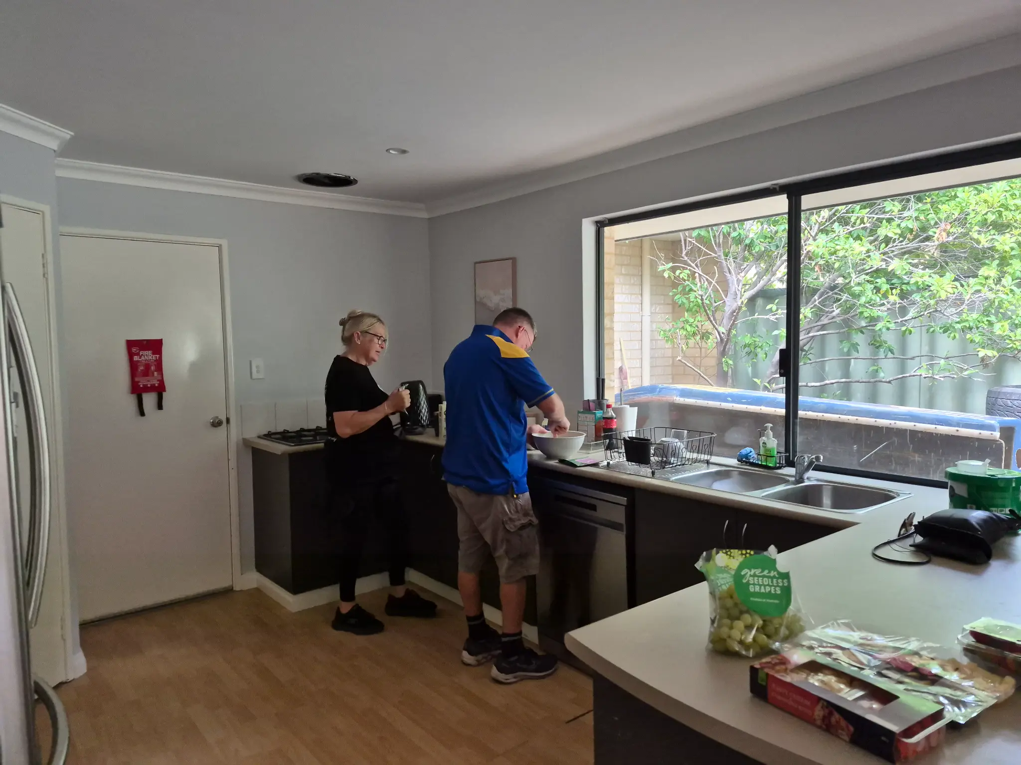 A support worker and participant preparing food at home