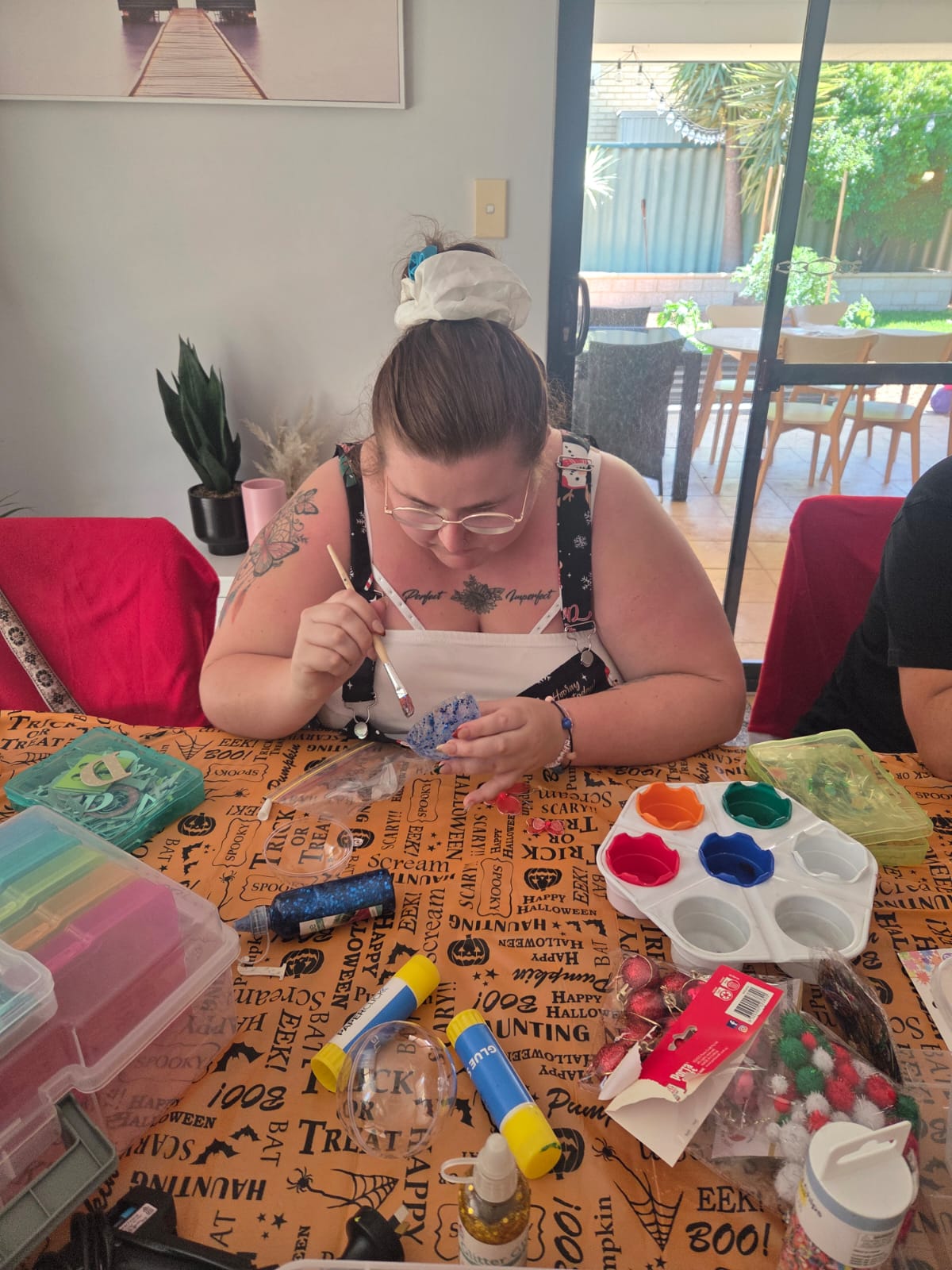 A participant painting a creative project at home